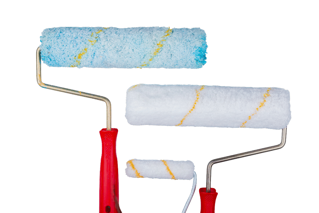 close up view paint rollers gray background