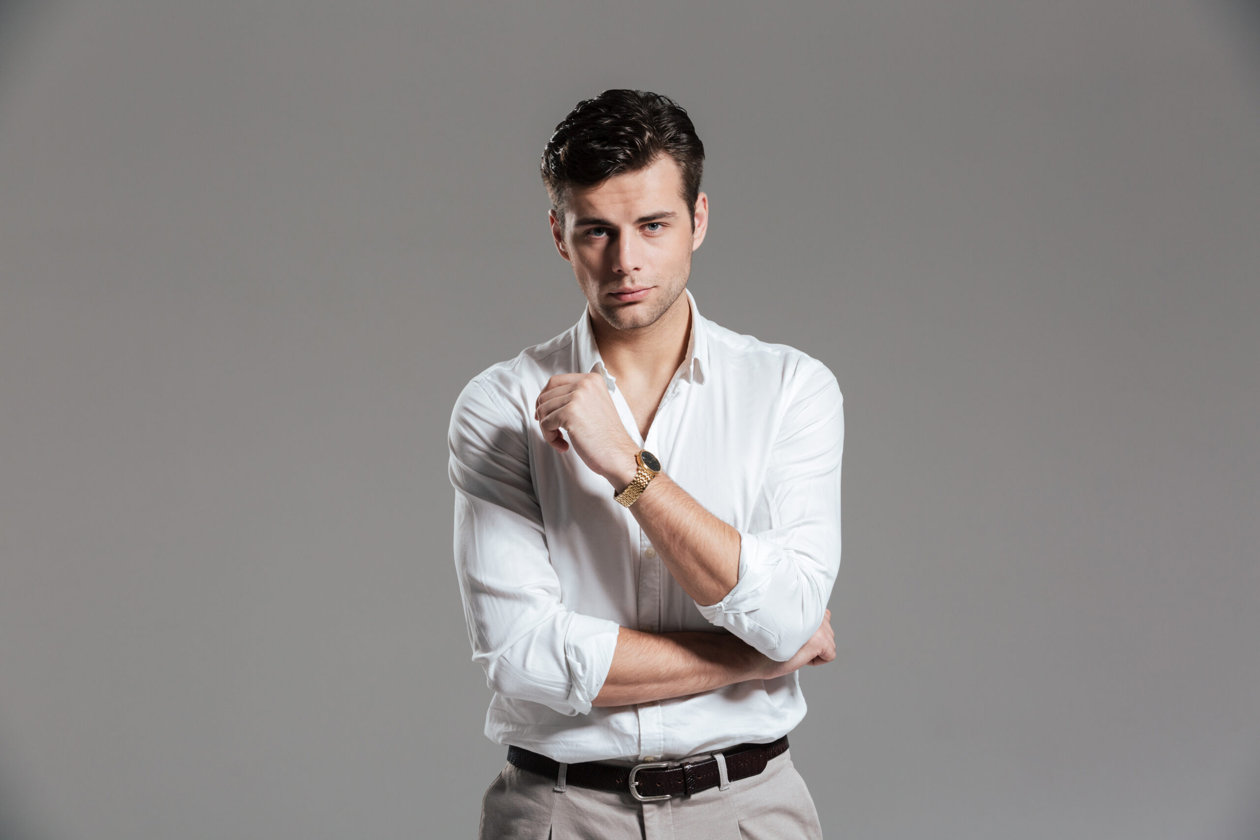 About portrait of a serious concentrated man in white shirt